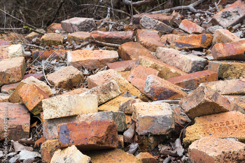 A pile of old bricks from the ruins of an old building. Bricks are approximately 100 years old. Orange and red colors are prominent