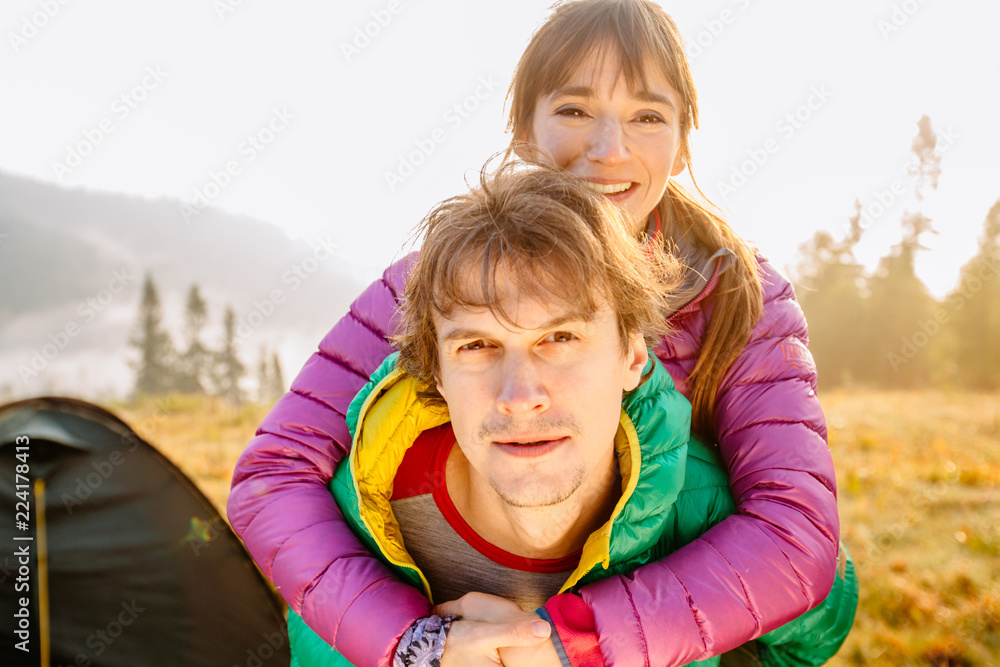Outdoor portrait of a beautiful middle aged couple traveler over beutiful mountains autumn landscape morning sunrise background. Outdoor portrait of a beautiful middle aged couple traveler over beutiful mountains autumn landscape morning sunrise background.