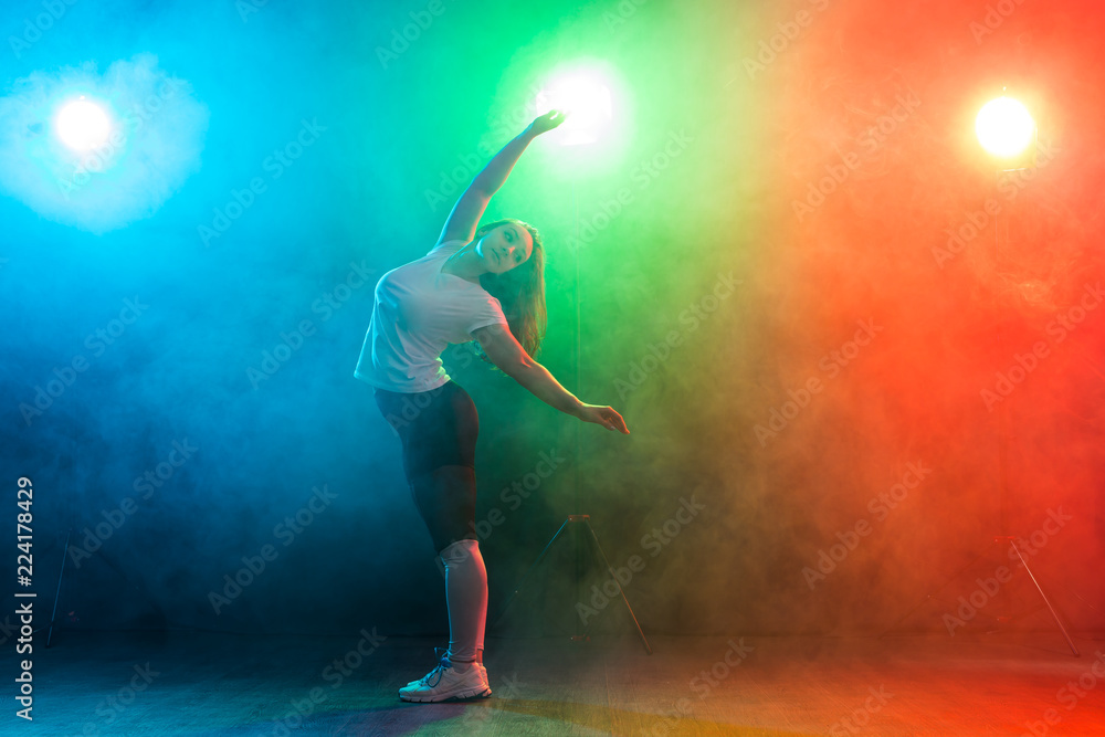 People and dancing concept- European young woman dancing jazz funk over colored background