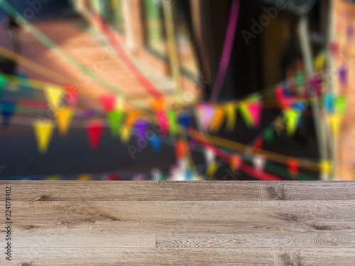 blank wooden table. Flooring. Multicolored flags in the store. Sale