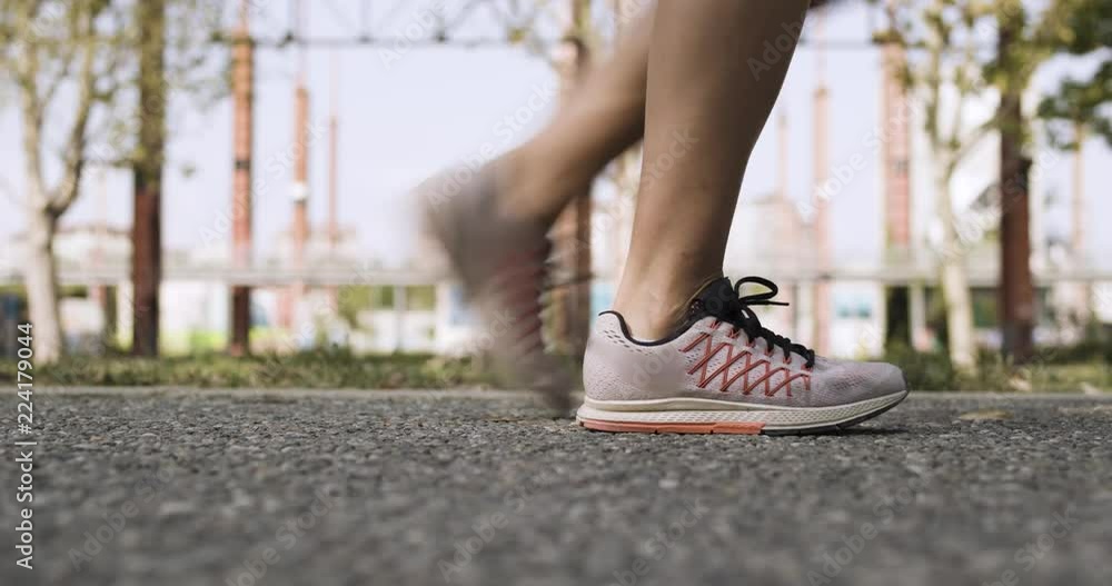 Young blond woman feets view starting running training.Summer sunny day.Industrial green city.Urban runner cardio healthy activity workout.4k slow motion 60p video Young blond woman feets view starting running training.Summer sunny day.Industrial green city.Urban runner cardio healthy activity workout.4k slow motion 60p video