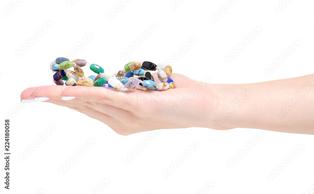 Beads colorful stones in hand on a white background isolation Beads colorful stones in hand on a white background isolation