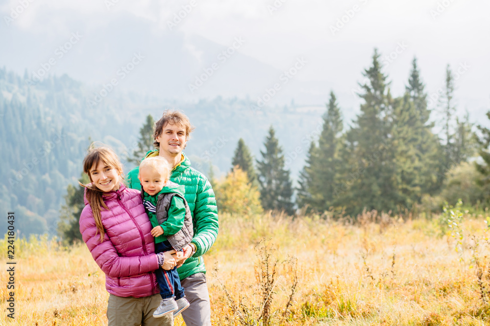 Family of Mother, Father and son are traveling on Carpathain mountains. Traveling with children, tourism and people concept. Copy space.