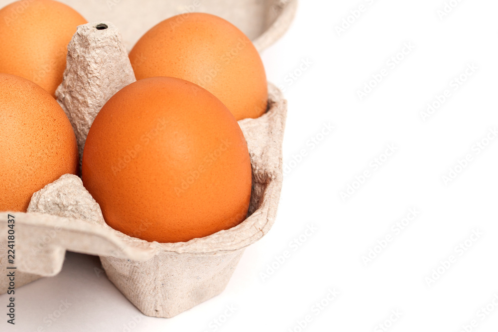 Eggs lies in a cardboard gray box on a white (isolated) background with copy space Eggs lies in a cardboard gray box on a white (isolated) background with copy space