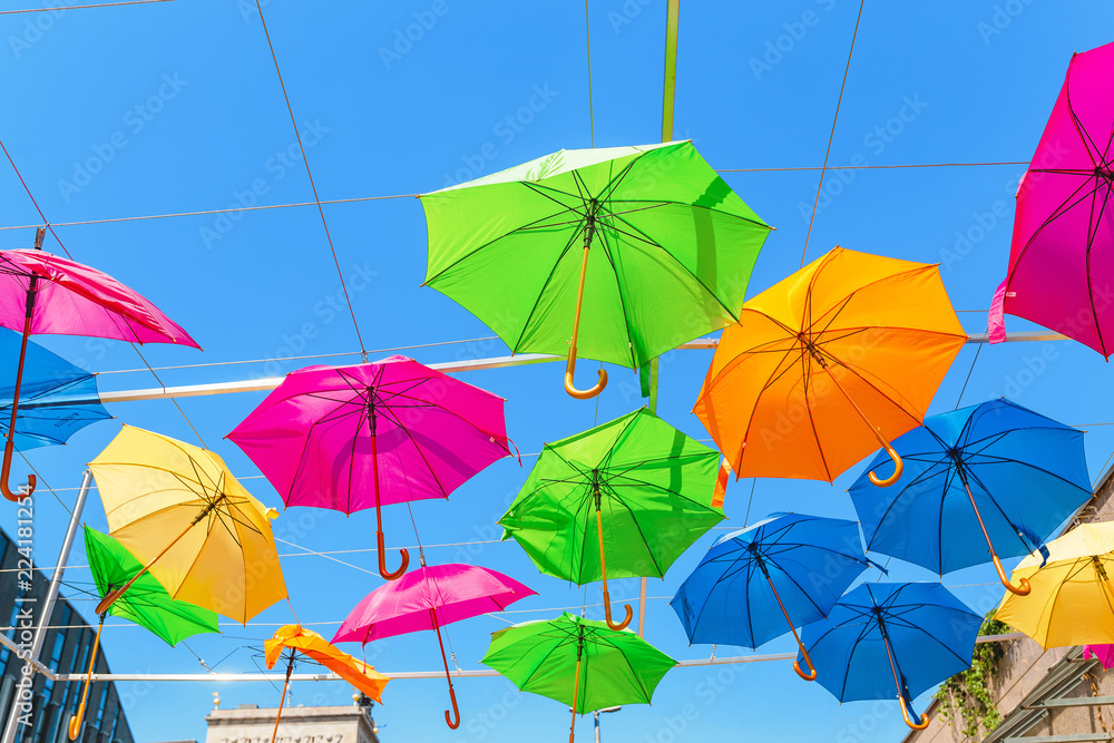 Multicolored umbrellas hanging in the outdoor cafe
