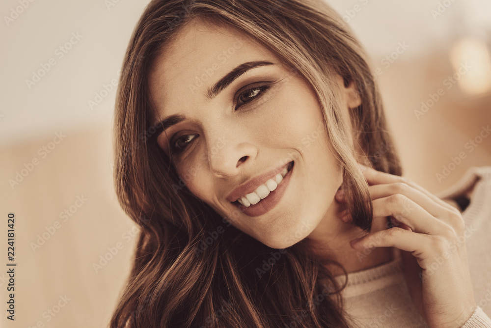 Fototapeta premium Broad smile. Charming woman feeling excited smiling broadly while feeling happy with her careful husband