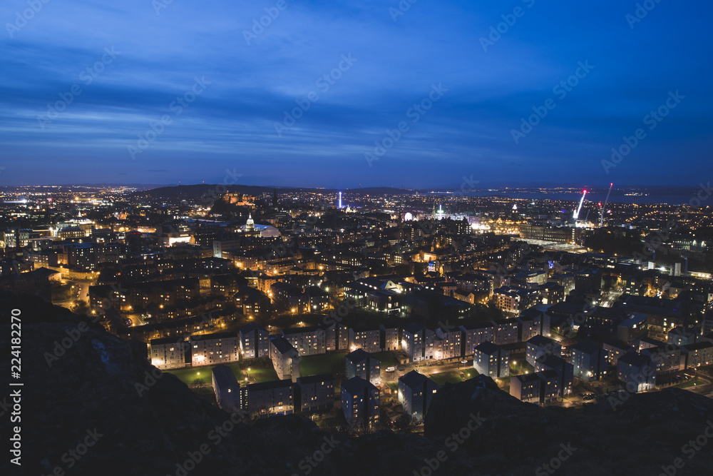Edinburgh City Skyline at night with Salisbury crags in the foreground