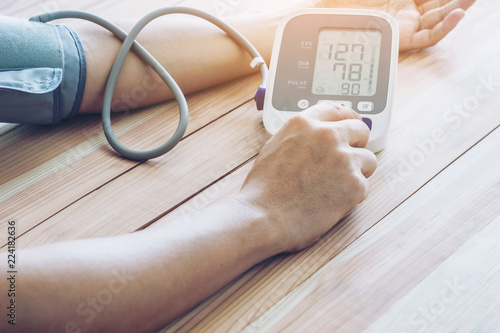 man is taking care for health with hearth beat monitor and blood pressure