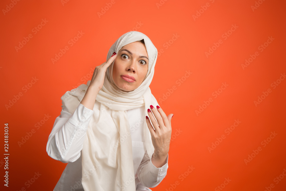 Argue, arguing concept.arab woman in hijab. Portrait of girl, posing at. red studio background. Young emotional woman. The human emotions, facial expression concept. Front view.