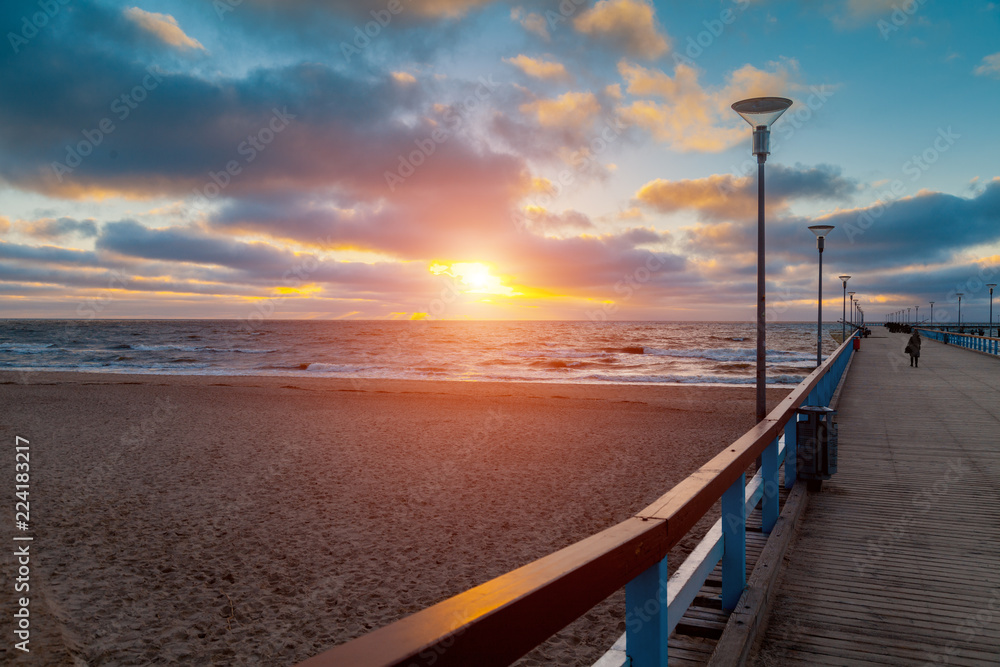 View of wooden pier over sea. Palanga city at sunset in autumn, Lithuania
