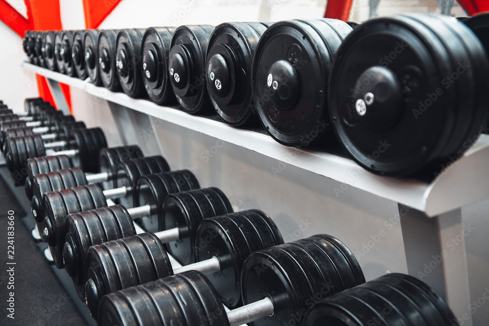 Gym and dumbbell weight training equipment on sport. Healthy life and gym exercise equipments and sports concept. Сopy space Gym and dumbbell weight training equipment on sport. Healthy life and gym exercise equipments and sports concept. Сopy space