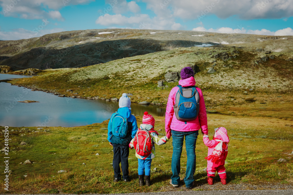 mother with kids travel hiking in mountains, family in Norway