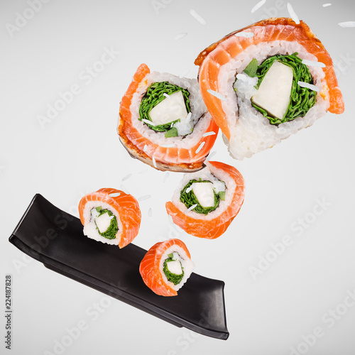 Pieces of delicious japanese sushi frozen in the air.