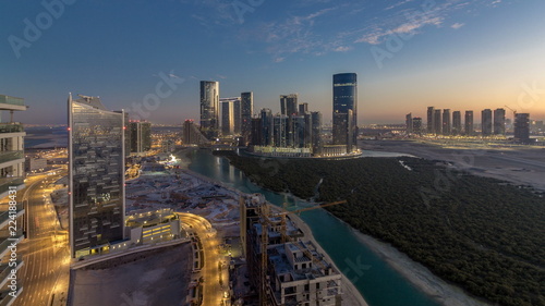 Buildings on Al Reem island in Abu Dhabi day to night timelapse from above. photo