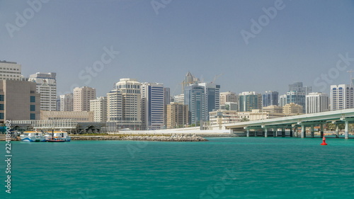 Modern buildings in Abu Dhabi skyline timelapse with mall and beach. © neiezhmakov