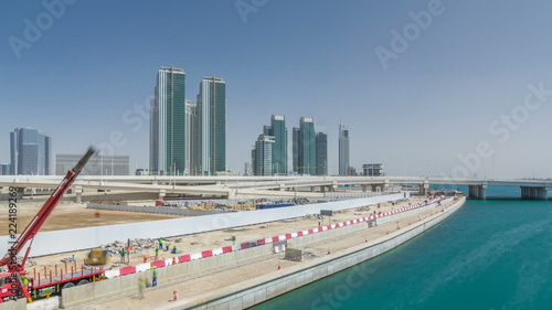 Modern buildings in Abu Dhabi skyline timelapse hyperlapse with waterfront.
