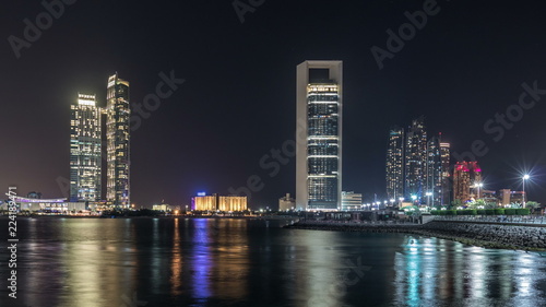 Panorama view of Abu Dhabi Skyline and seafront at night timelapse  United Arab Emirates