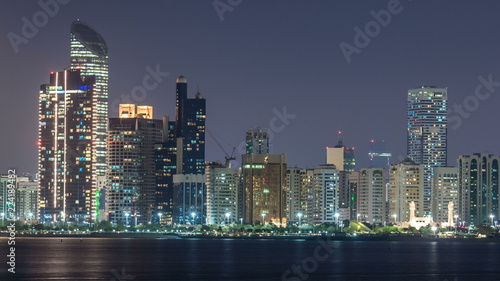 Panorama view of Abu Dhabi Skyline and seafront at night timelapse, United Arab Emirates © neiezhmakov