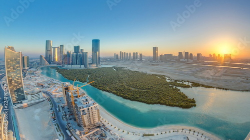 Buildings on Al Reem island in Abu Dhabi at sunset timelapse from above.