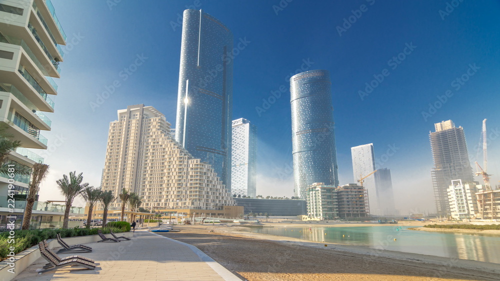 Fototapeta premium Buildings on Al Reem island in Abu Dhabi timelapse hyperlapse