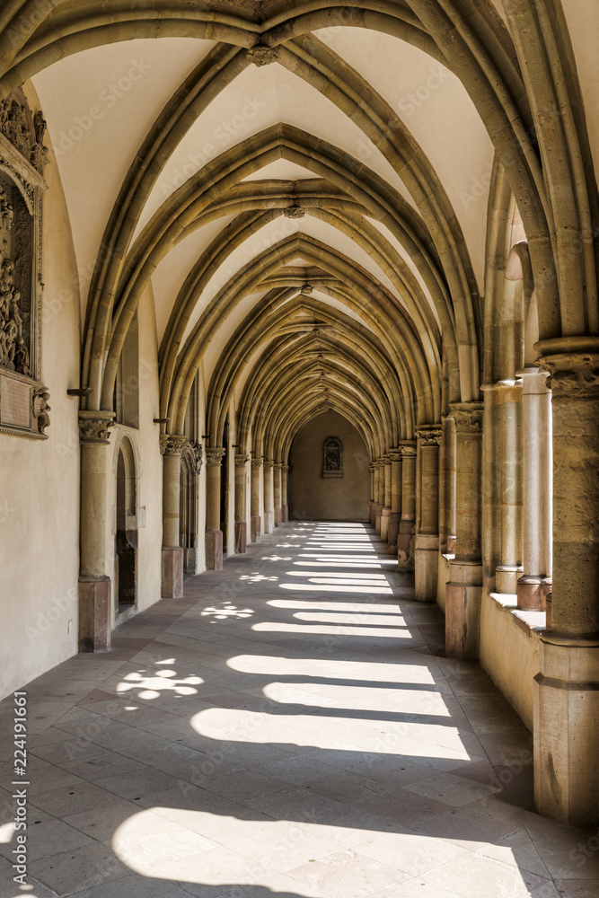 Sunlight through the arches of a corridor in a medieval cloister