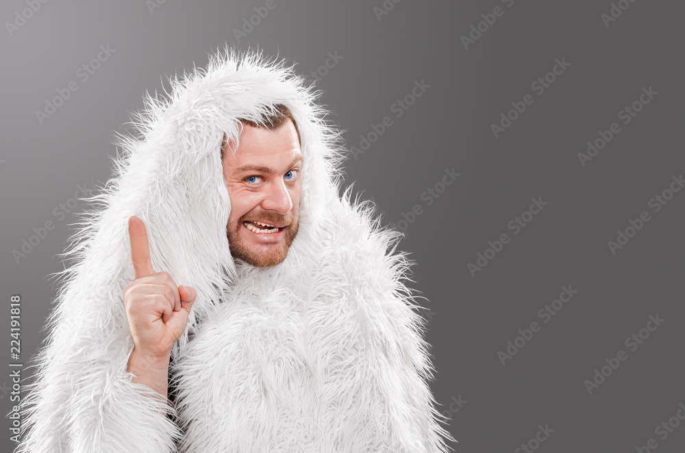 Obraz premium Caveman in animal skin on isolated background shows thumb up