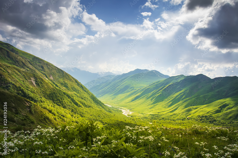 Mountains ranges. Mountain landscape in Svaneti, Georgia. Beautiful view on grassy hills and highlands on summer sunny day with cloudy sky. Scenery mountains nature.