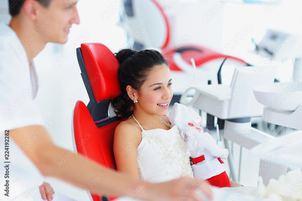 Young beautiful girl with a doctor in a dental office on a survey. Young beautiful girl with a doctor in a dental office on a survey.