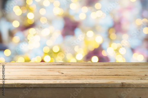 Empty wooden table over festive bokeh background