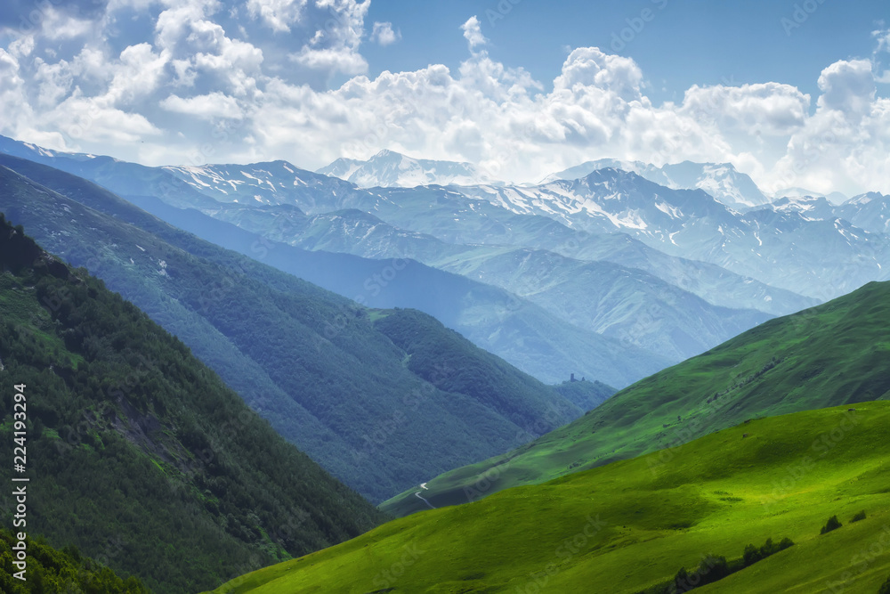 Mountains nature landscape on sunny summer day. Mountains ranges in Svaneti, Georgia. Scenery Hills and mountain. Amazing mountain range. Alpine. Green meadow covered by grass in highlands