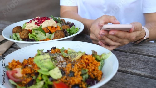 Wallpaper Mural Female Hands Using Mobile Phone On Food Table Having Lunch With Vegan Salads Torontodigital.ca
