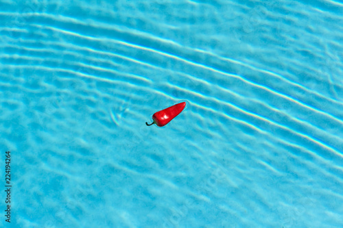 red hot chilie pepper on blurry water background