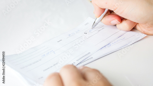 Canvastavla Closeup image of person writing bank cheque for charity purposes