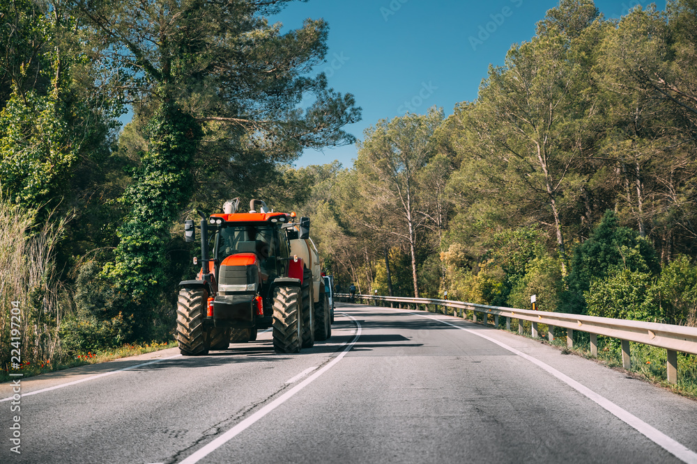 Fototapeta premium Tractor With Fertilizer Applicator With Tank In Motion On Countr