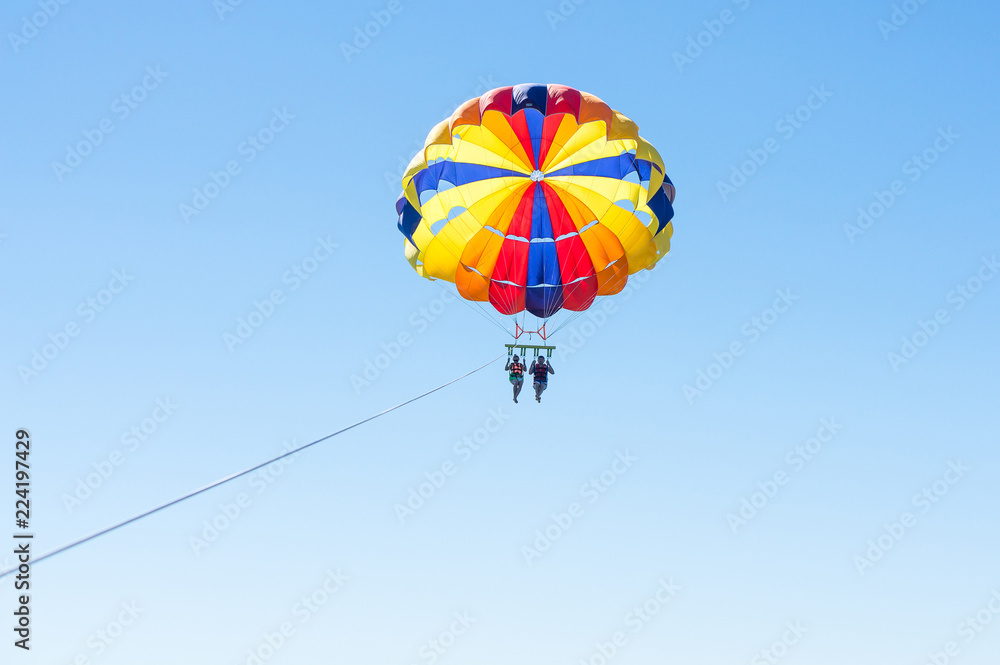 Happy couple Parasailing in Dominicana beach in summer. Couple under parachute hanging mid air. Having fun. Tropical Paradise. Positive human emotions, feelings, family, children, travel, vacation. Happy couple Parasailing in Dominicana beach in summer. Couple under parachute hanging mid air. Having fun. Tropical Paradise. Positive human emotions, feelings, family, children, travel, vacation.