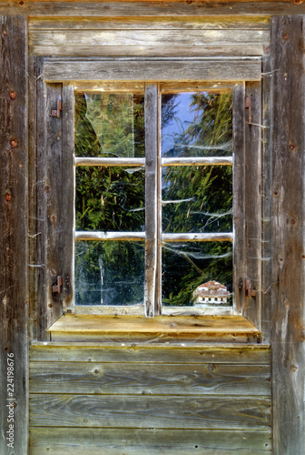 Old wooden window of a farm house photo