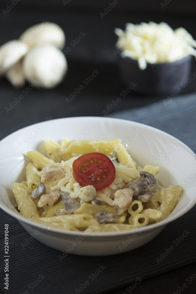 penne pasta on dark background penne pasta on dark background