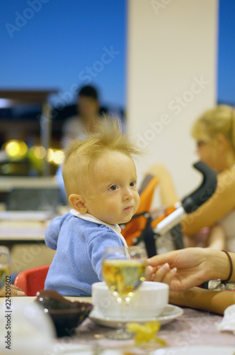 Cute baby eating by herself and she looking on food stick hand
