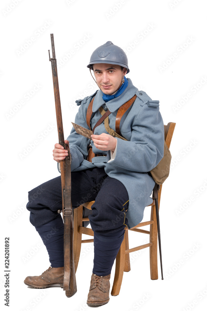 French soldier 1914 1918, sitting on chair, reading letter isolated on white background French soldier 1914 1918, sitting on chair, reading letter isolated on white background