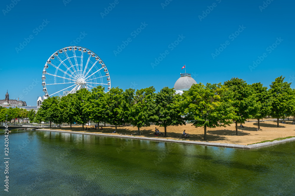 MONTREAL, QUEBEC / CANADA - JULY 15 2018: Ferris wheel of Montreal MONTREAL, QUEBEC / CANADA - JULY 15 2018: Ferris wheel of Montreal