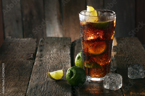 Cocktail with ice coke and lime photo