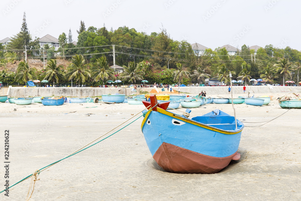 Blue fishing boat on sandy beach in Vietnam Blue fishing boat on sandy beach in Vietnam