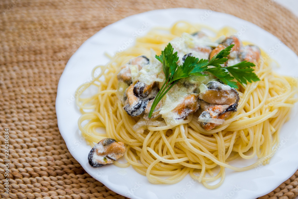 Traditional italian seafood pasta with clams. Spaghetti with mussels in creamy sauce