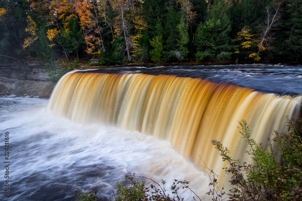 Fototapeta premium Autumn Waterfall Landscape Panorama. Tahquamenon Falls landscape in autumn in panoramic orientation. Tahquamenon Falls State Park, Upper Peninsula, Michigan. 