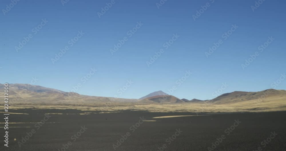 Payunia National Park, Payun Liso, Payun Matrú and Herradura volcano at background. Colourfull mountains with red, black lapillis and golden grasses. Camera stays still. Malargüe, Mendoza, Argentina Payunia National Park, Payun Liso, Payun Matrú and Herradura volcano at background. Colourfull mountains with red, black lapillis and golden grasses. Camera stays still. Malargüe, Mendoza, Argentina