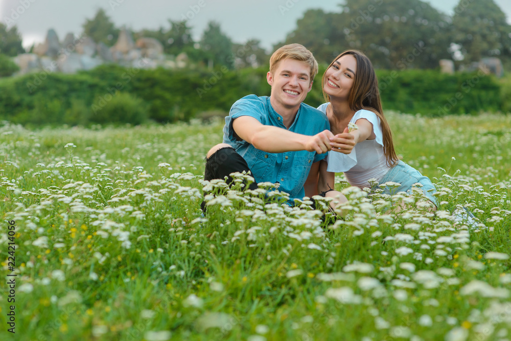 Fototapeta premium Young couple gives flowers