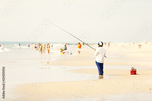 Fisher man fishing at a beach in Nam Tien, Vietnam