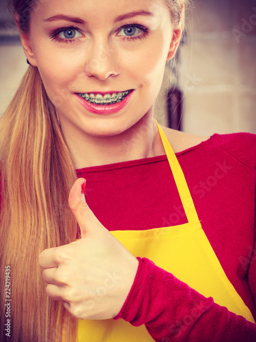 Happy smiling blonde woman wearing apron photo