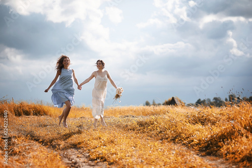 Two girls in dresses in autumn field