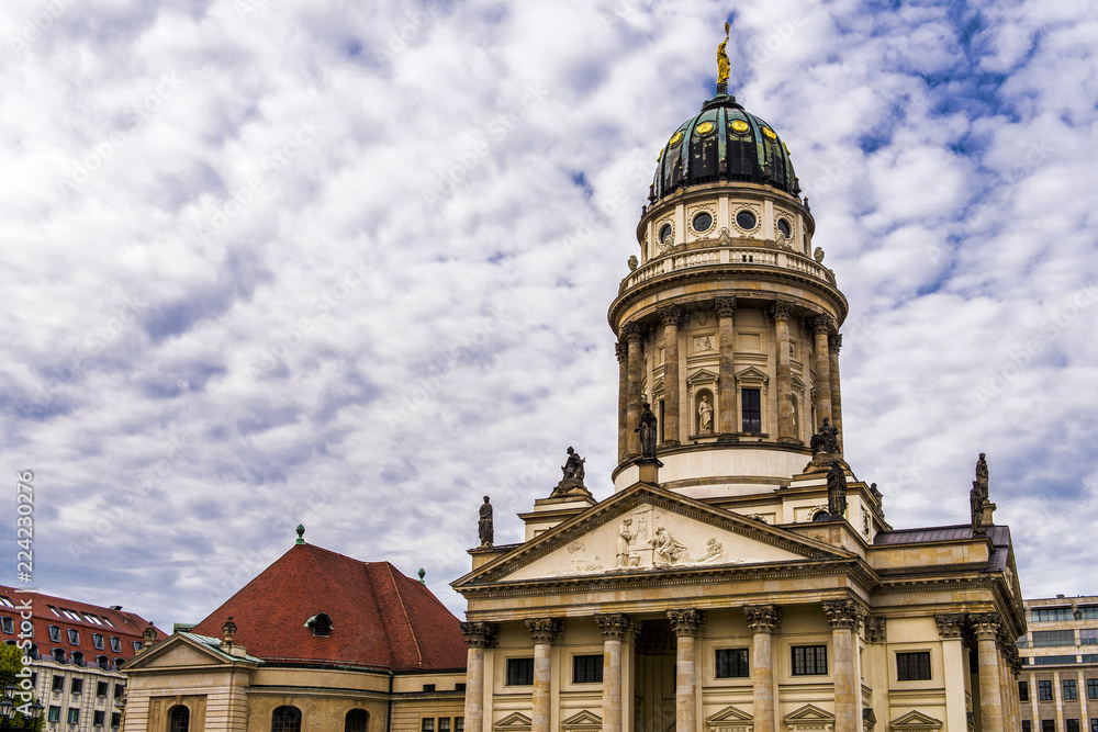 Fototapeta premium The Gendarmenmarkt is a square in Berlin and the site of an architectural ensemble including the Konzerthaus (concert hall) and the French and German Churches. This being the French Church